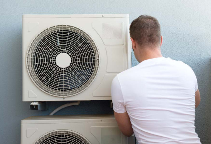 Man Maintaining AC